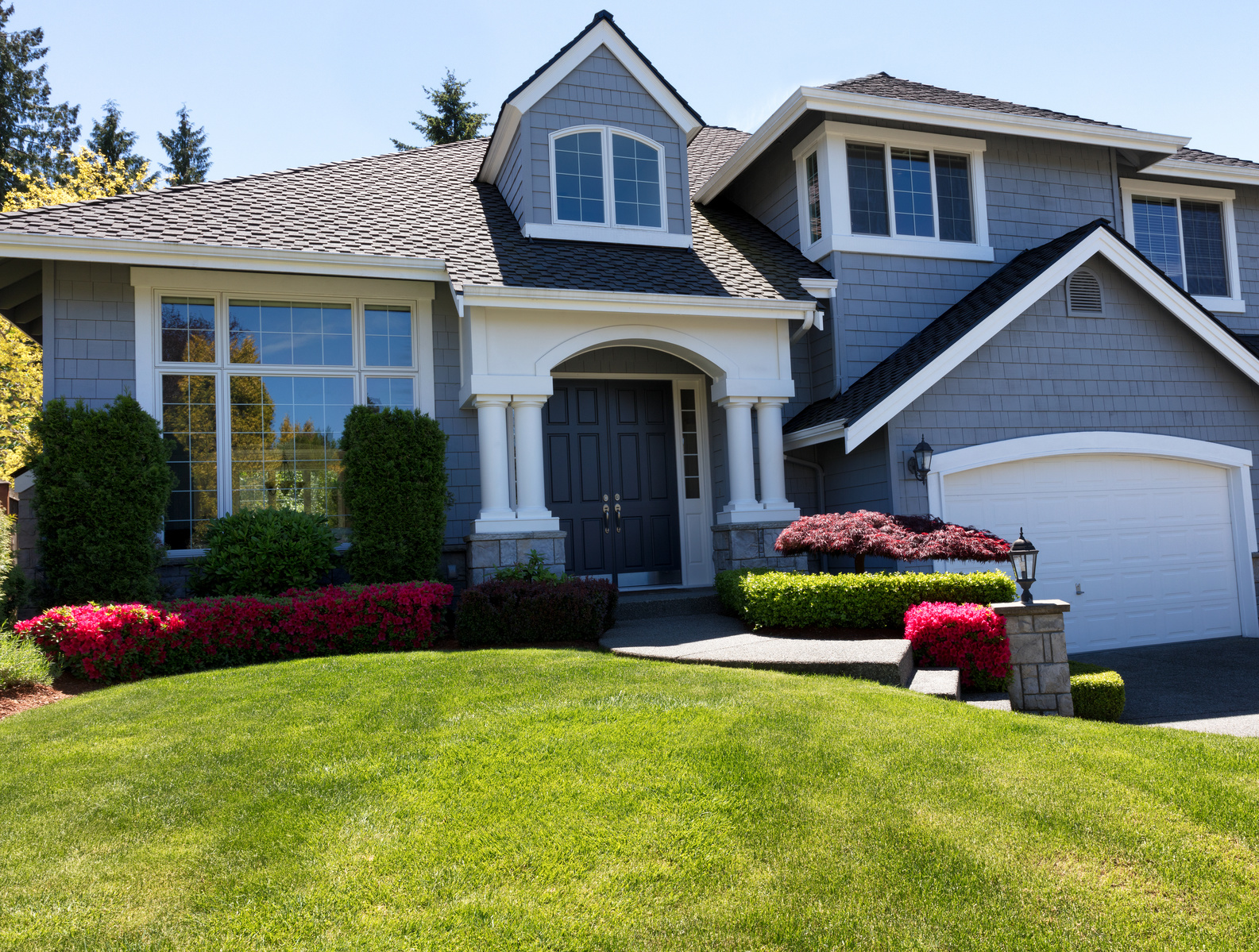 Front view of a well maintained front yard of home during a nice spring day